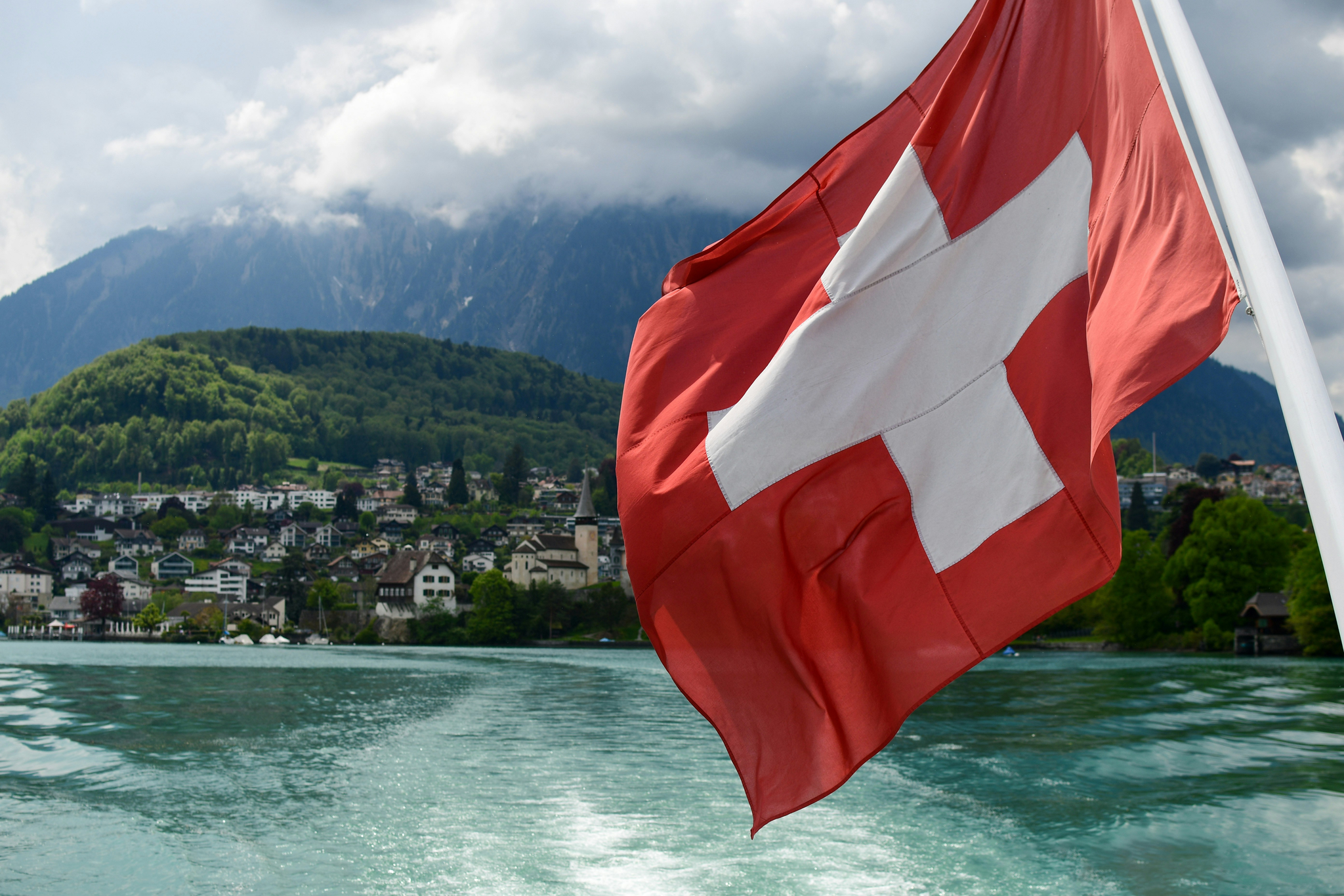 View of Switzerland with country flag on foreground.